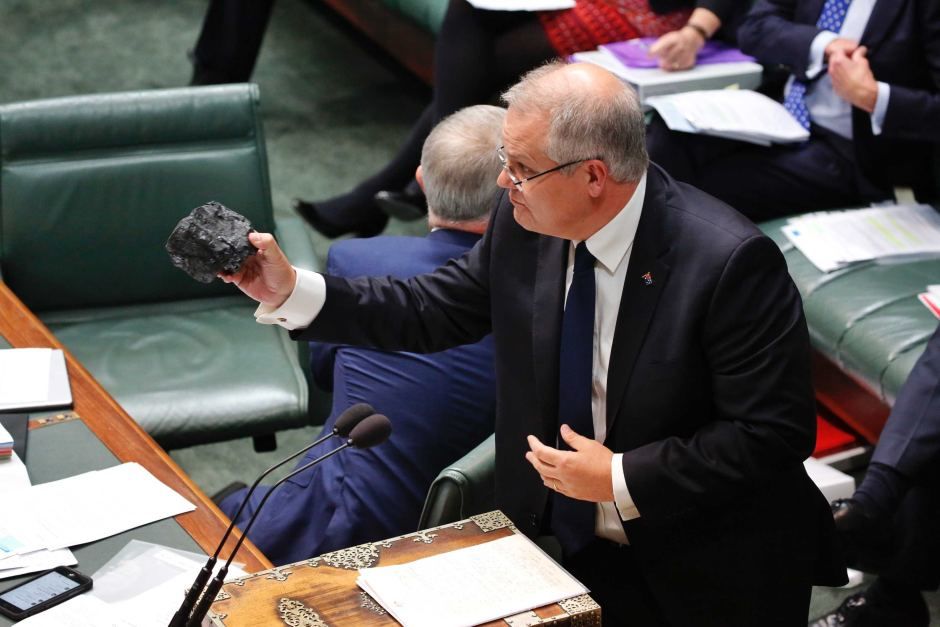 Australia's new prime minister, Scott Morrison, holds a piece of coal during a sitting of parliament in April. [Australian Parliament]