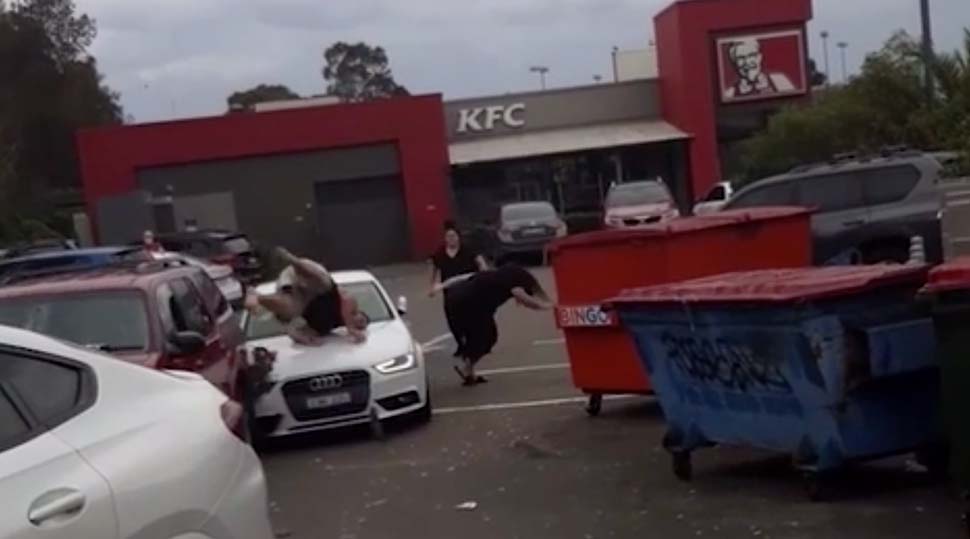 A man and a woman are seen being hit by an Audi in a KFC parking lot. Neither were seriously injured. (Facebook)