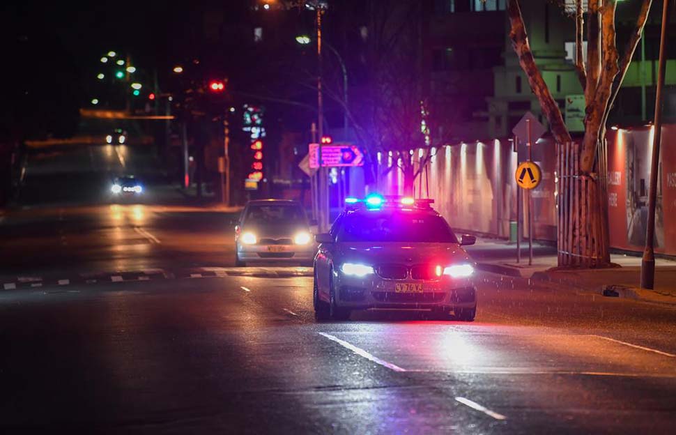 A police vehicle patrols the main street in the suburb of Merrylands. Credit James D. MorganGetty Images
