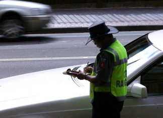시드니의 주차 미터기, 사라질지도 A parking inspector issues a ticket to a car parked on Macquarie Street in Sydney's CBD. (SMH Wade Laube)