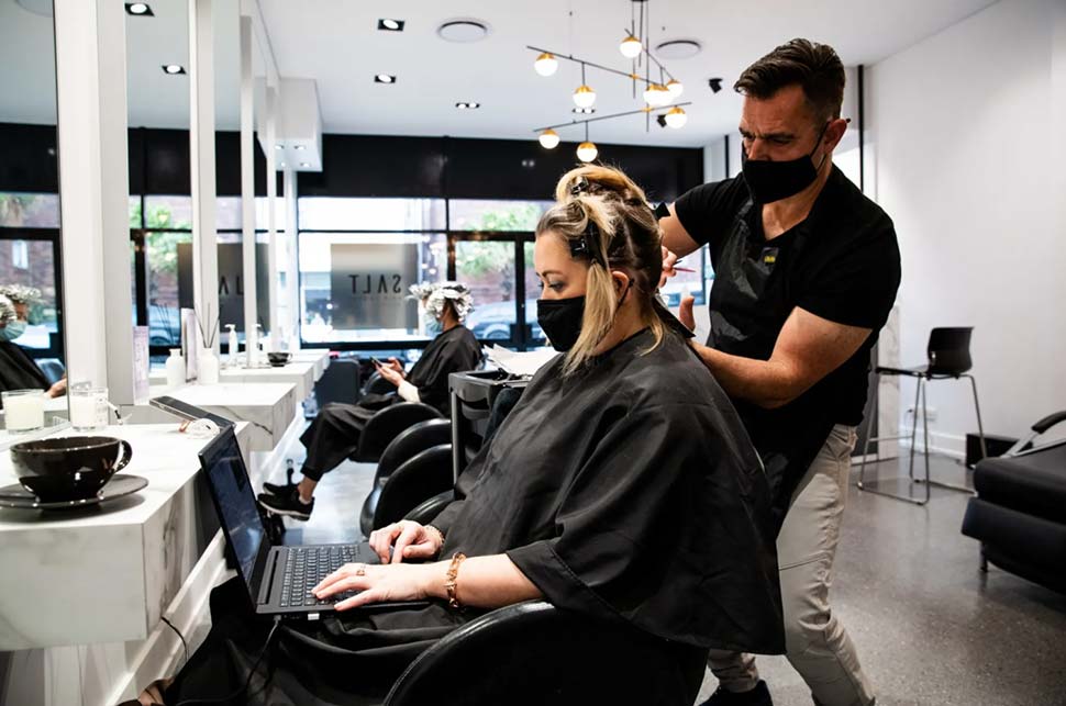 Hairdresser Tony Boutsalis from Salt Hair in Coogee with customer Helen Appleton. CREDIT:EDWINA PICKLES