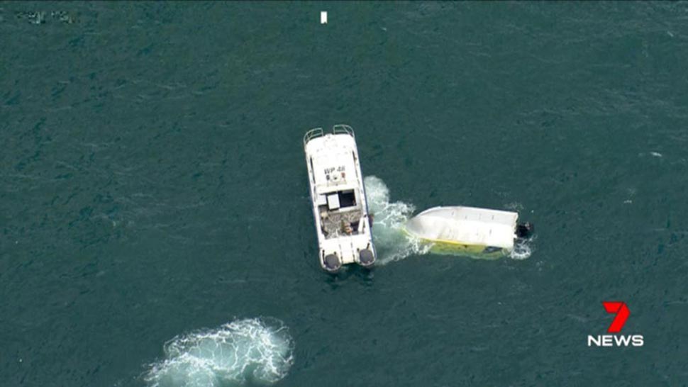 A person has died despite resuscitation efforts after a boat capsized off Wollongong with six others aboard. Credit: 7NEWS
