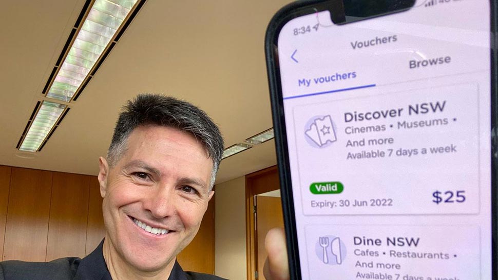 Digital and Customer Service Minister Victor Dominello with the NSW Government's Service NSW app showing the Dine & Discover vouchers. Source LinkedIn