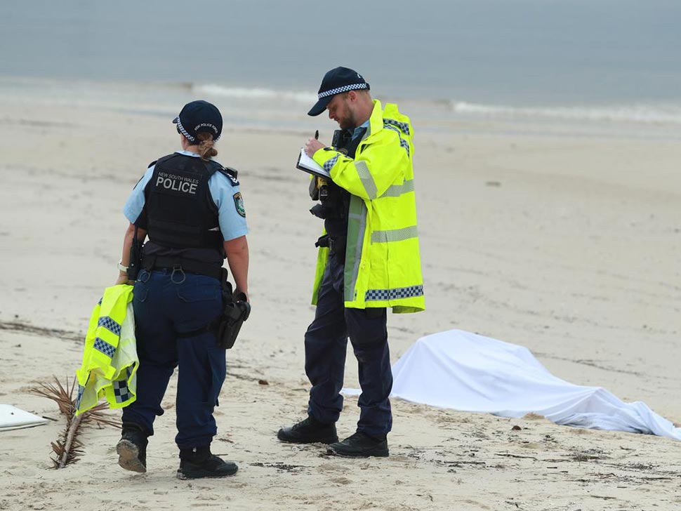 Police guard a body that was washed up on Lady Robinsons Beach at Brighton Le Sands. Picture John FederThe Daily Telegraph