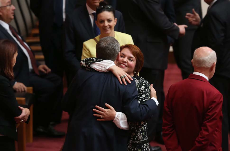 Senator Kimberley Kitching is embraced by then-opposition leader Bill Shorten after her first speech in the Senate at Parliament House in 2016. CREDIT ANDREW MEARES