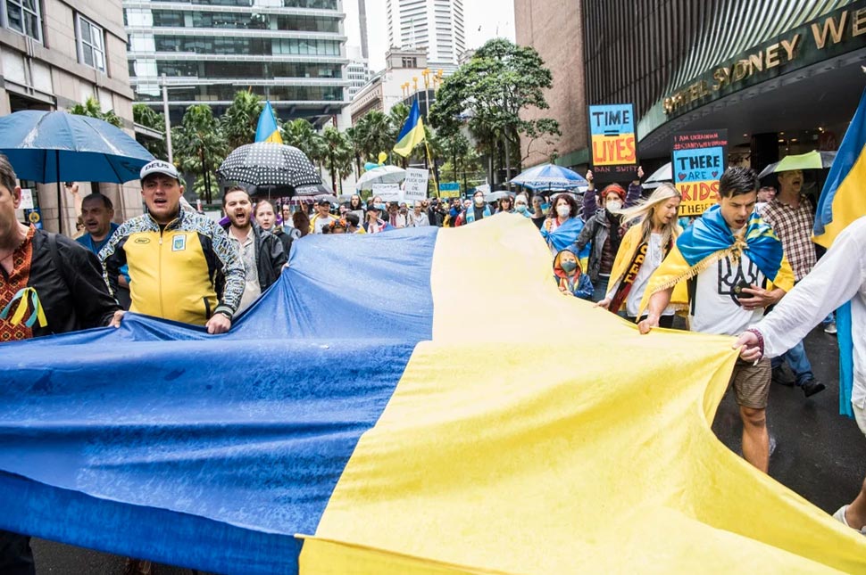 The Ukrainian flag is carried along Elizabeth Street in Sydney during the Stop War in Ukraine rally.CREDITSTEVEN SIEWERT