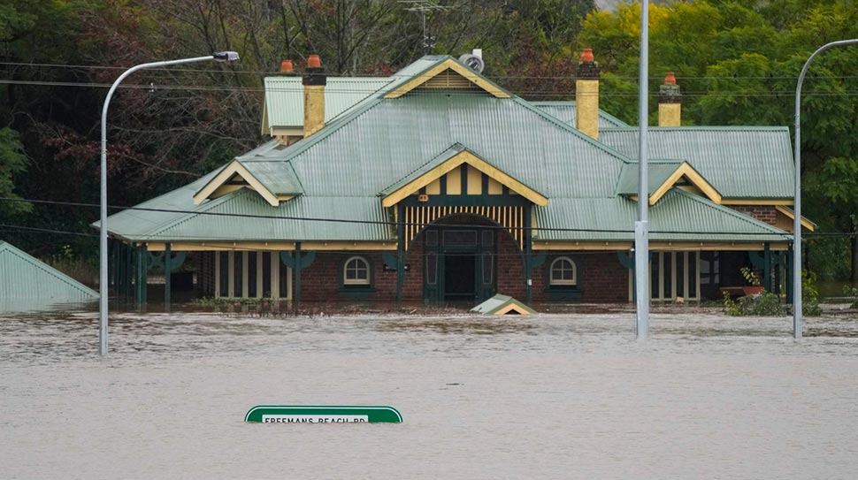 A building is inundated with water on the far side of the Windsor Bridge at Windsor on the outskirts of Sydney. (AP)