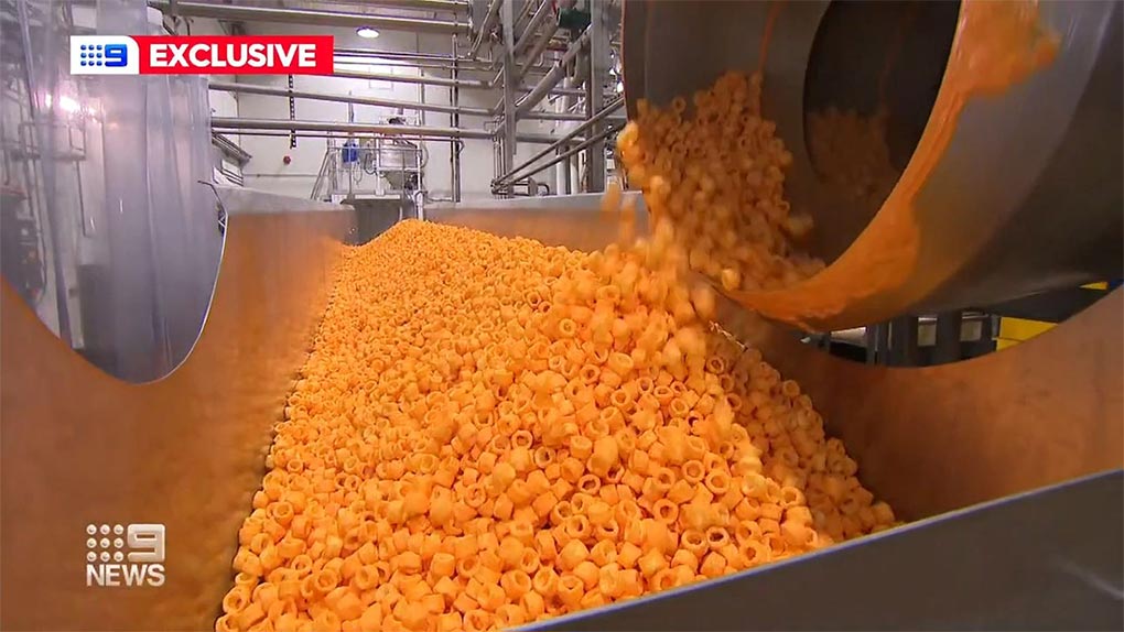The Snackbrands factory in Smithfield pumps out 750 kilograms of Cheezels every hour. (Nine)