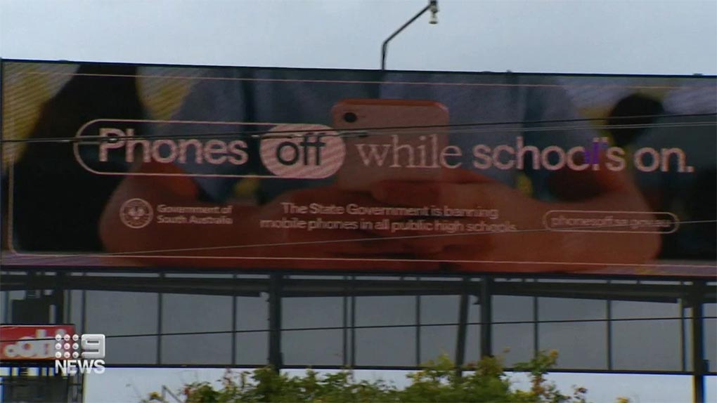 The government's new $900,000 awareness campaign aims to help enforce the public high school ban, which all schools need to enforce by term three. (Nine)