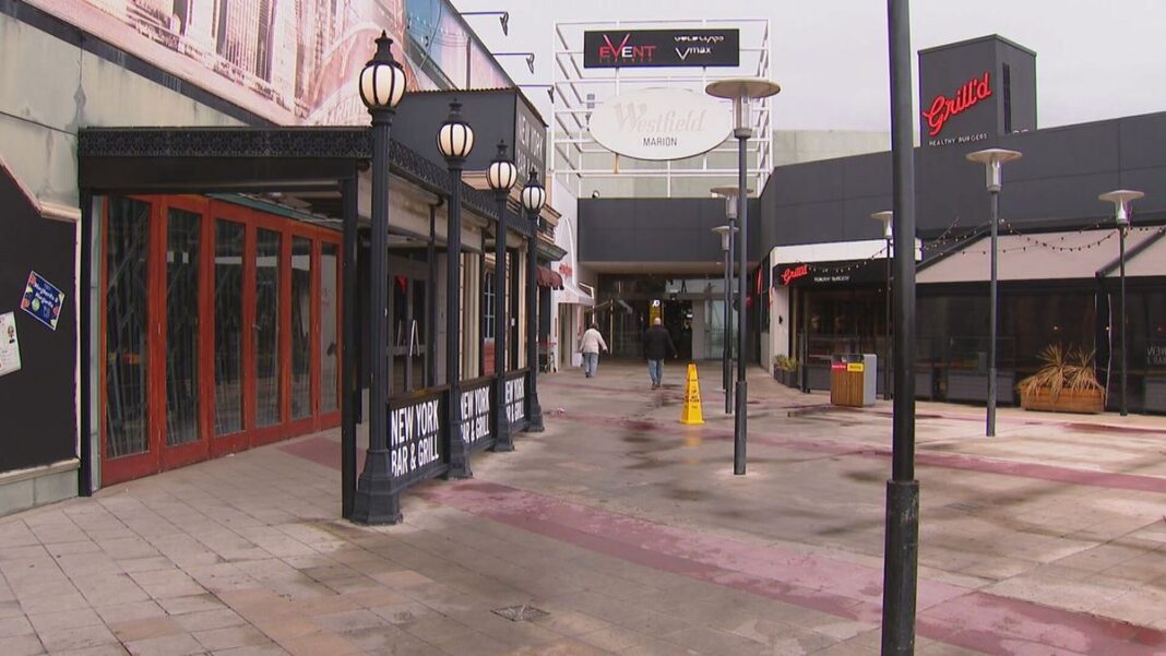 A machete and extendable batons were allegedly brandished during the robbery of a teen that sparked a lockdown and evacuation at Adelaide's biggest suburban shopping mall. (9News)