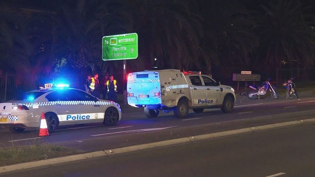 Police are searching for the driver of a white Mazda involved in an alleged road rage attack in western Sydney that has left a motorcycle rider seriously injured overnight. (Nine)