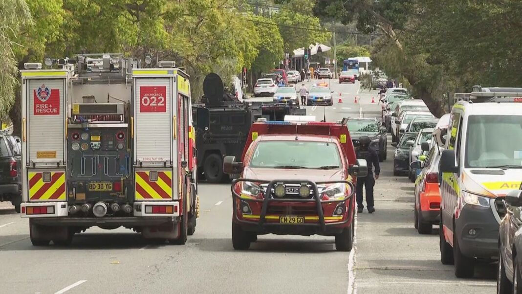 A man who allegedly threatened people with a machete on a street in Sydney's inner west before he ran into a nearby house has been charged by police. (Nine)