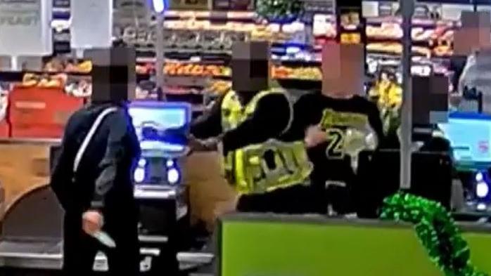 Newly released footage also shows a customer threatening to shiv security workers at a Woolworths self-checkout. Picture Supplied.NEWS.COM.AU