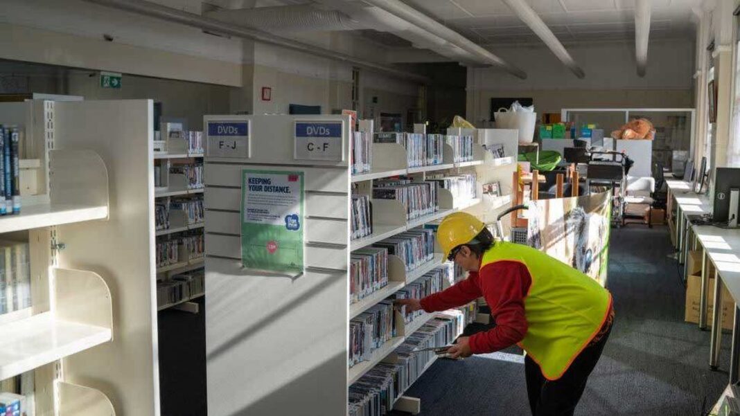 Richmond Tweed Acting Regional Library Manager Lucy Kinsley is seen here restocking the library in 2023 with books donated by Australia Post. (Australia Post)