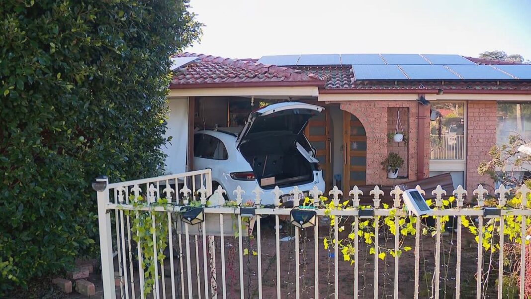 Police are looking for two people after a Porsche ploughed into a house in Sydneys southwest. (Nine)
