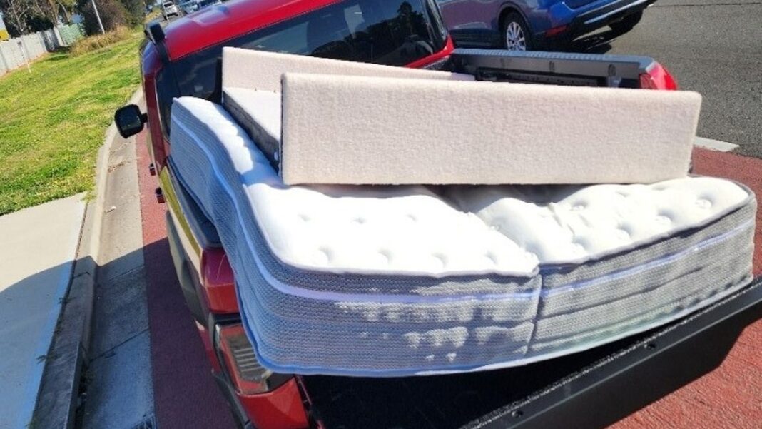 Officers in Liverpool stopped a Kia Tasman over the weekend after spotting the large mattress in the back of the car, not tied down with anything. (NSW Police)
