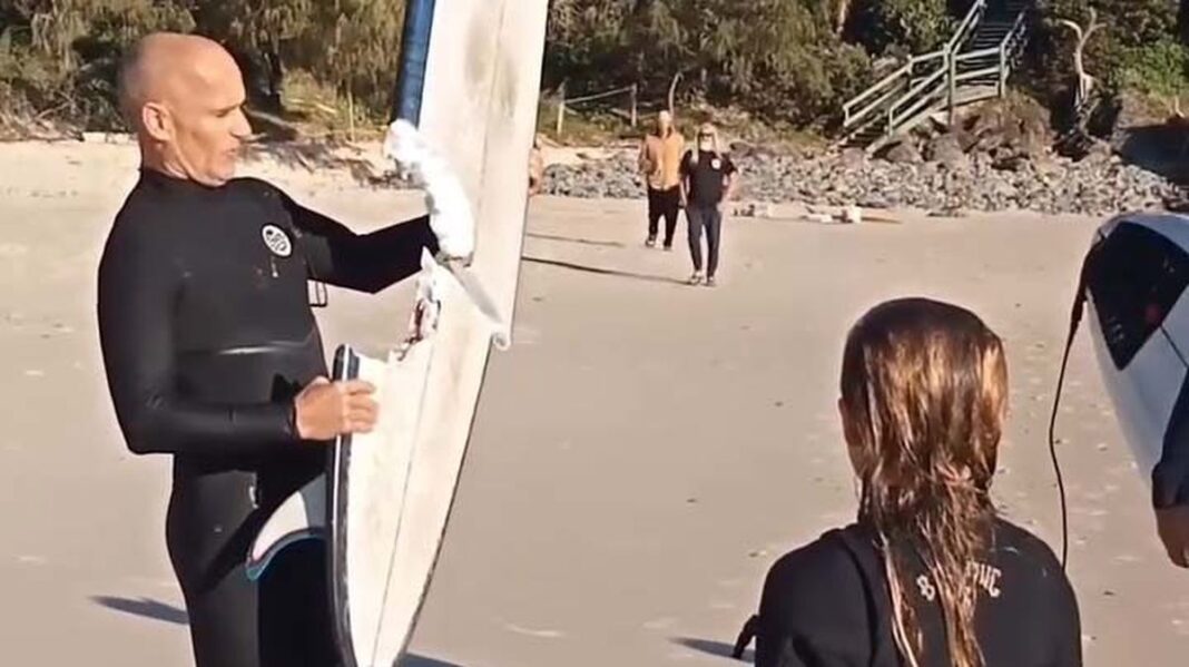 .Video posted on Facebook shows the surfer standing with the remains of the board on the beach. (Nine)