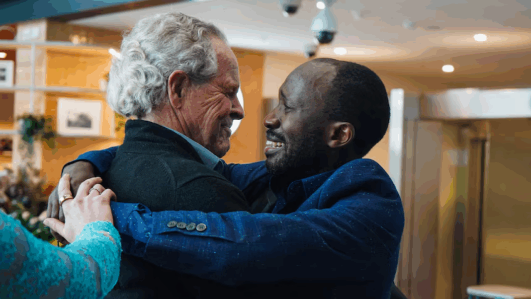 A hug three decades in the making between Bruce Anschau and Edward Kankaka. (ABC News_Bridget Murphy)