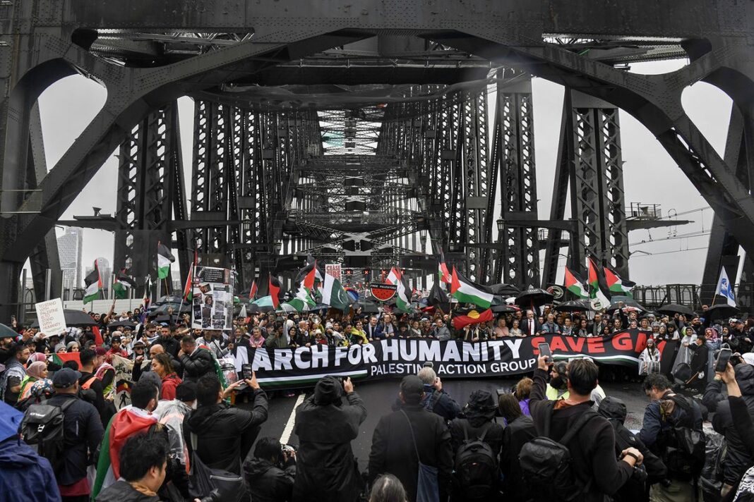Pro-Palestinian protesters march across the Sydney Harbour Bridge to call for an end to Israel's war in Gaza. (Dean Sewell)_9news