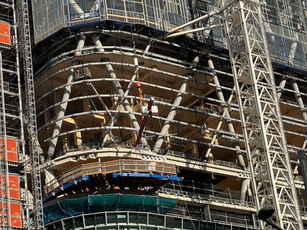A close-up reveals the 39-storey Atlassian Central Tower rising above Sydney’s Central Station. Dominating the skyline, the tower’s distinctive “timber habitats” span 21 of its floors.woodcentral.com.au