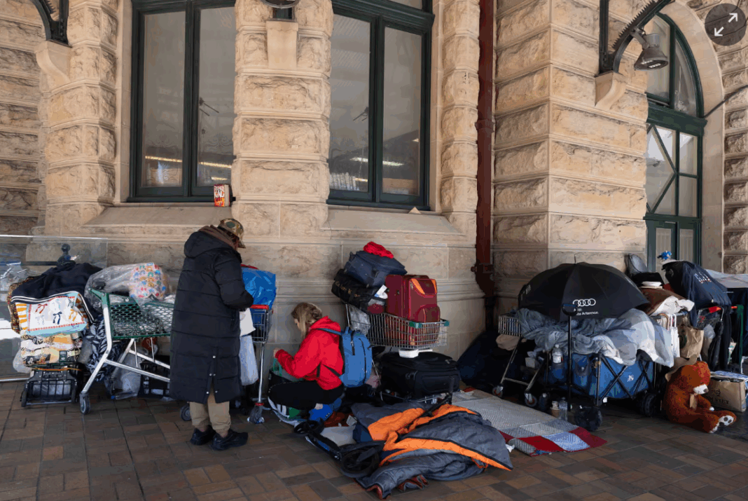 Rough sleepers, having been moved on from other places in Central station, set up in a spot exposed to the elements but covered by a security camera. Photograph: Jessica Hromas/The Guardian