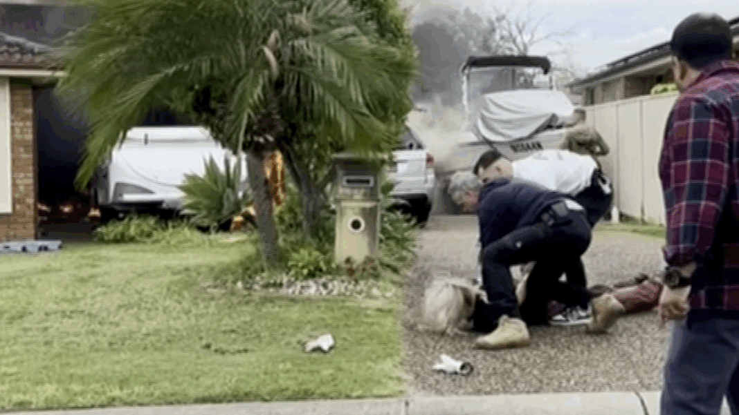 The son was cuffed by police out the front of the home. Credit 7NEWS