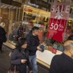 7.Shoppers walk past a sale sign in a Melbourne shopping centre. (Eamon Gallagher)_9news