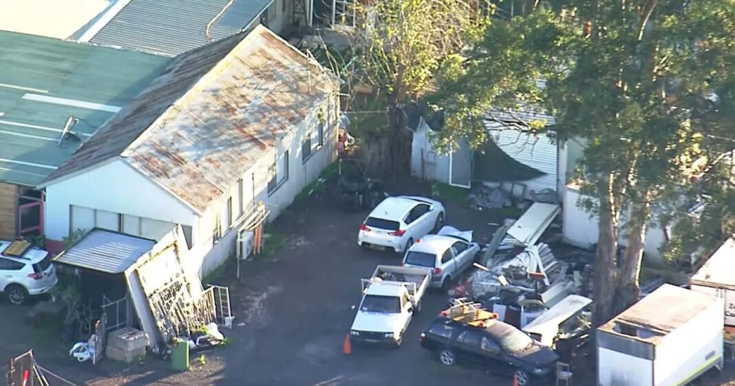 Officers set up a perimeter around the home in Burley Road, Horsley Park. Nine