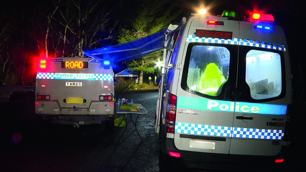 Forensic teams battled the elements as they attempted to keep rain off evidence at the scene. Credit 7NEWS